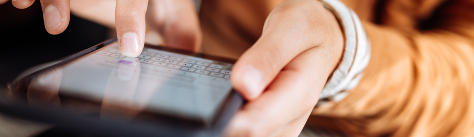 hands holding mobile phone typing